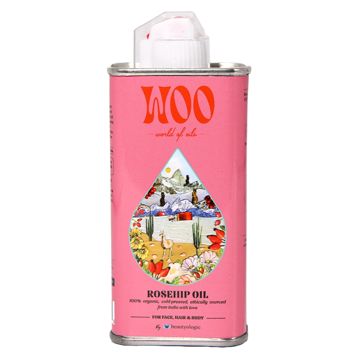 Pink canister of WOO rosehip oil with a colorful label on a white background