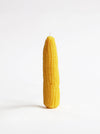 A novelty candle shaped like a corn cob, standing upright on a clean white background.