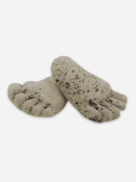 Hand carved volcanic pumice stones in the shape of a small foot