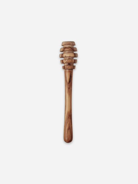 A wooden honey dipper with a natural olive wood grain pattern, shown vertically against a plain light gray background.