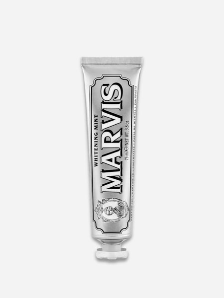 A silver squeeze tube of Marvis Whitening Mint toothpaste, centered on a light gray background.