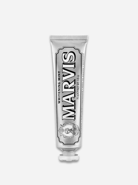 A silver squeeze tube of Marvis Whitening Mint toothpaste, centered on a light gray background.