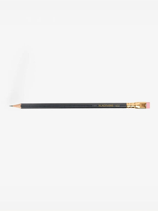 A single black pencil with gold lettering and a pink eraser, shown horizontally against a plain white background.