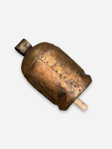 An antique bronze bell with engraved markings and a wooden mallet, shown on a light gray background.