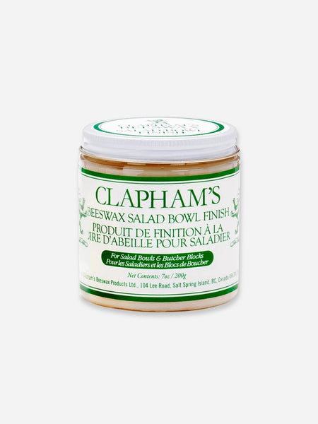 A jar of Clapham's Beeswax Salad Bowl Finish, featuring a white label with green text and borders, set against a plain light gray background.