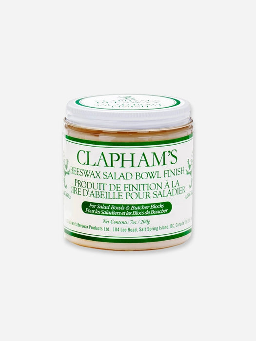 A jar of Clapham's Beeswax Salad Bowl Finish, featuring a white label with green text and borders, set against a plain light gray background.