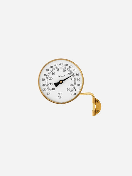 A round analog thermometer with a gold-toned metal frame and bracket, featuring a white face with black markings in Celsius and Fahrenheit, shown against a light gray background.