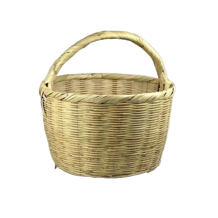 A natural woven straw basket with a single integrated handle, shown against a white background.