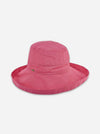 A pink wide-brimmed sun hat with a small green embroidered logo on the front, displayed against a light gray background.
