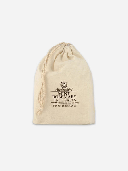 A drawstring pouch of ElizabethW Mint Rosemary Bath Salts, made of off-white canvas with black trim and a white label, set against a light grey background.