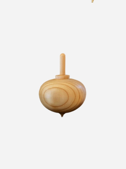 A small wooden toy spinning top with a natural light wood finish, shown against a plain light gray background.