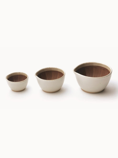trio of ceramic bowls on a white background