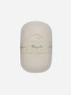 An oval-shaped cream-colored soap bar wrapped in a beige paper band labeled 'Magnolia' on a light gray background.