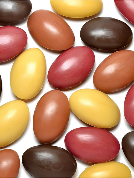 A group of oval-shaped beige bars of scented soaps shown on a plain light gray background.