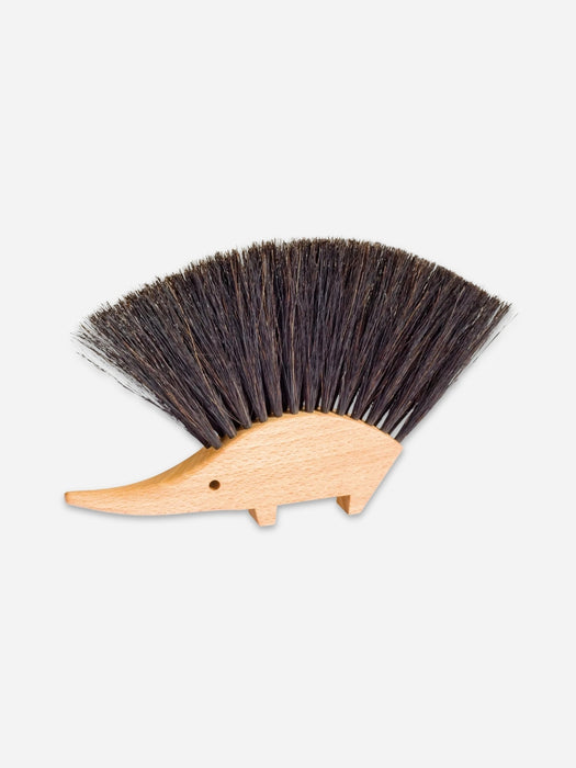 A hedgehog-shaped wooden hair bristle brush with dark brown to black bristles and a light natural wood body, shown on a plain light gray background.
