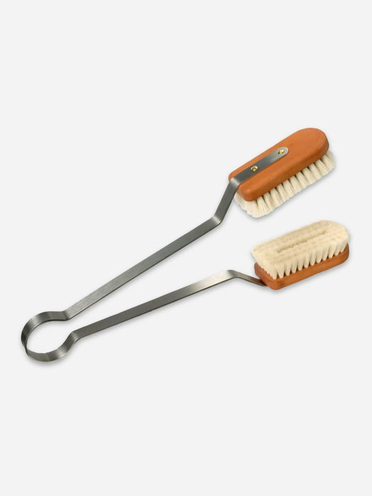 A pair of long-handled metal cleaning brushes with light brown wooden handles and cream-colored bristles, shown on a light gray background.