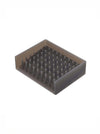 A rectangular gray silicone or rubber soap tray with dense upright bristles, shown on a plain white background.