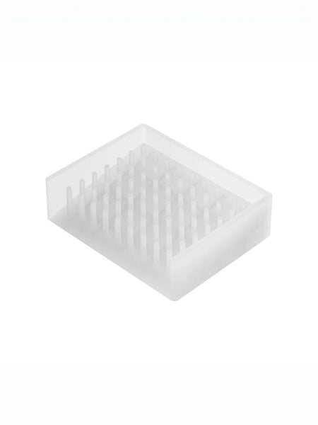 A translucent white silicone or plastic soap tray with a grid of small upright prongs, shown on a plain white background.