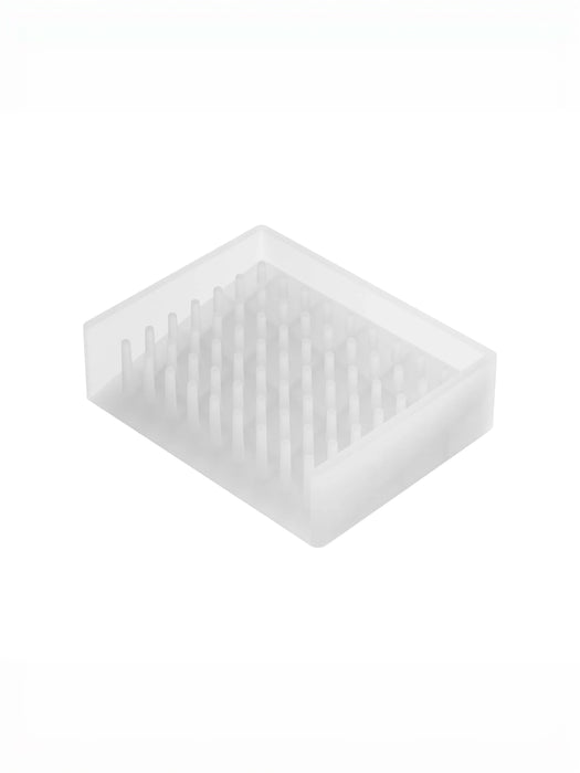 A translucent white silicone or plastic soap tray with a grid of small upright prongs, shown on a plain white background.