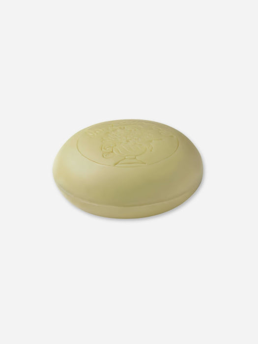 A round, pale yellow bar of soap embossed with the words 'La Lavande' and a floral design, set against a plain white background.