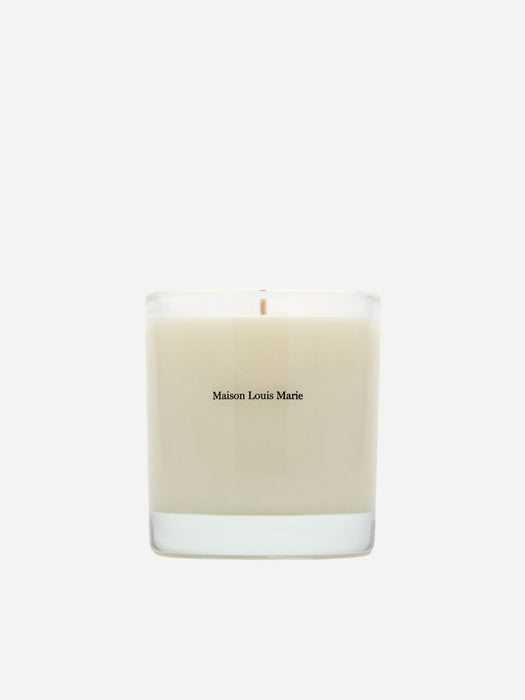A Maison Louis Marie scented candle in a clear glass jar with cream-colored wax, centered on a light gray background.